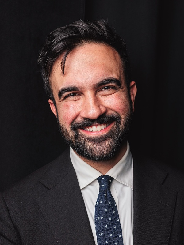 Zohran Mamdani nuovo sindaco di new york posa in abito elegante sorridente